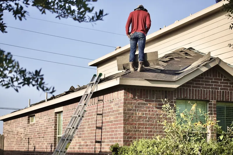 Professional roofer working on a residential roof in Shawsheen Village